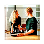 An acrylic square display block with a couple smiling and holding a spatula, with the text 'The Millers' at the bottom.